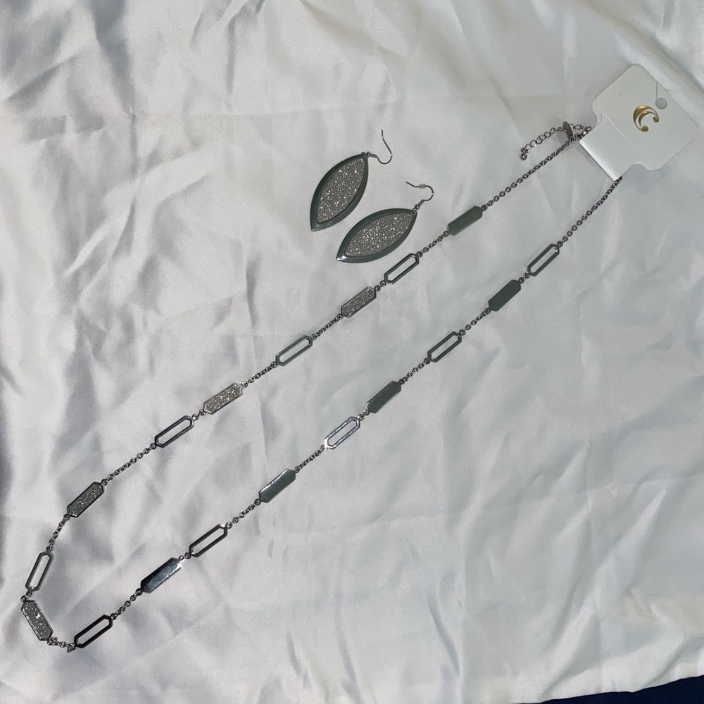 Charming Charlie’s long silver necklace with matching earrings.